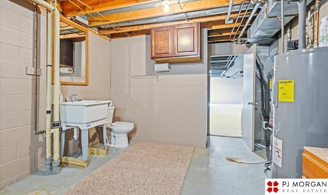 unfinished below grade area featuring water heater and concrete block wall