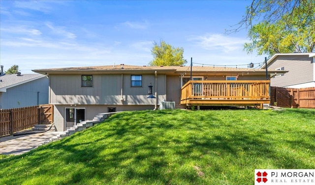 back of house featuring a lawn, a fenced backyard, stairs, and a deck