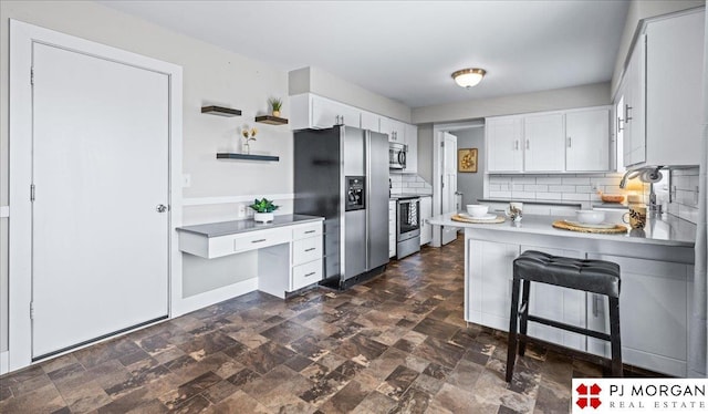 kitchen featuring tasteful backsplash, open shelves, a peninsula, stainless steel appliances, and white cabinetry