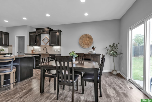 dining room featuring recessed lighting, visible vents, plenty of natural light, and dark wood finished floors