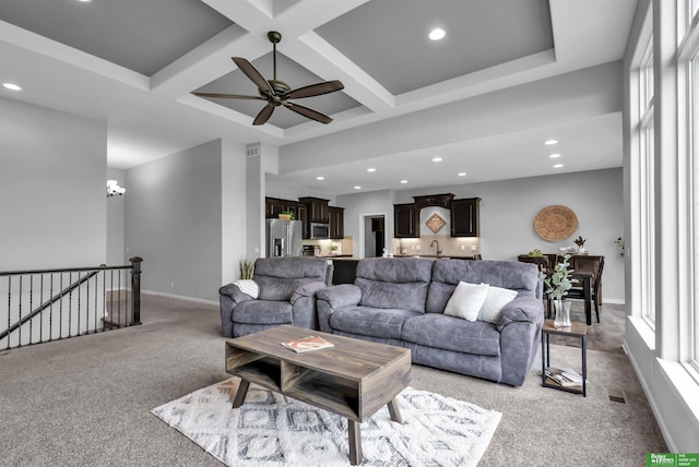 living area featuring ceiling fan, carpet floors, recessed lighting, visible vents, and coffered ceiling