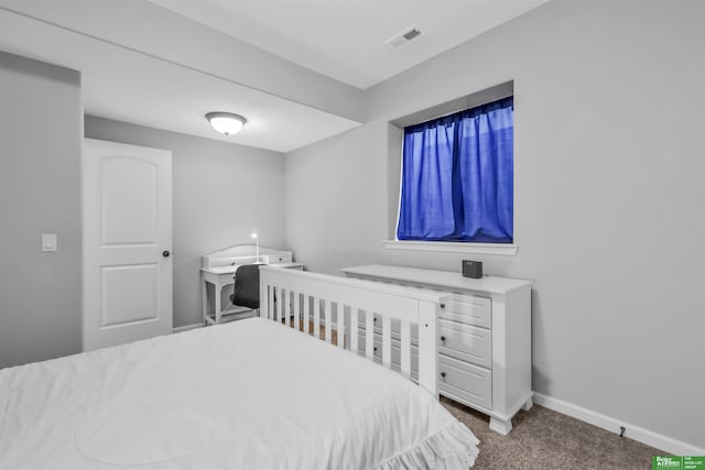 carpeted bedroom with visible vents and baseboards