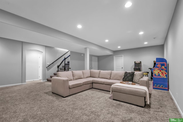 carpeted living area with baseboards, arched walkways, recessed lighting, and stairs