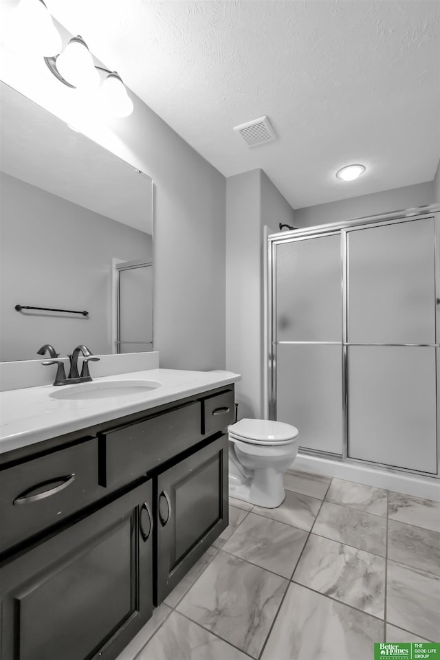 full bathroom featuring visible vents, a stall shower, vanity, toilet, and marble finish floor