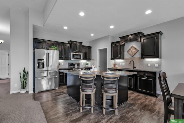 kitchen featuring tasteful backsplash, a kitchen island, a breakfast bar, and stainless steel appliances