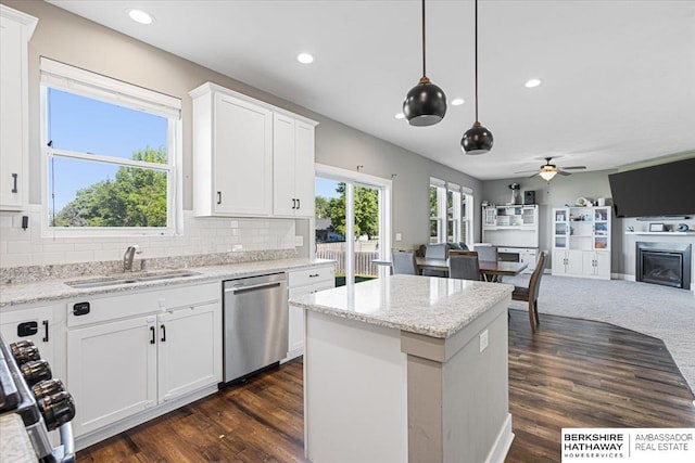 8230 Kilpatrick Pkwy, Bennington, NE 68007 - kitchen with dishwasher, a sink, open floor plan, a ceiling fan, and a kitchen island