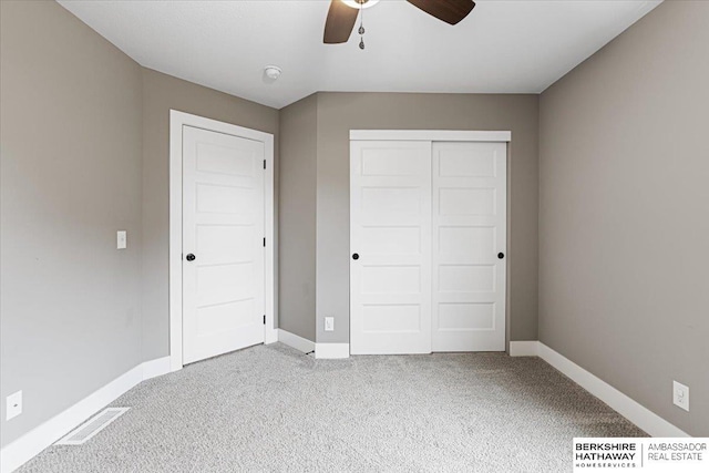8230 Kilpatrick Pkwy, Bennington, NE 68007 - unfurnished bedroom with carpet, a closet, baseboards, and a ceiling fan