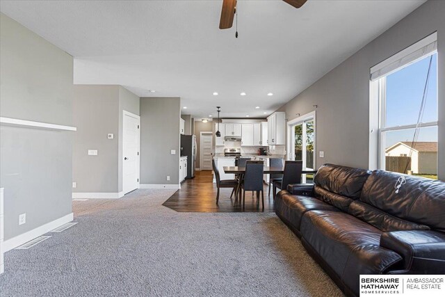 8230 Kilpatrick Pkwy, Bennington, NE 68007 - living area with carpet floors, a ceiling fan, baseboards, and recessed lighting