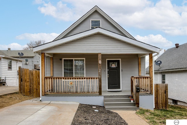 view of front of home with covered porch and fence