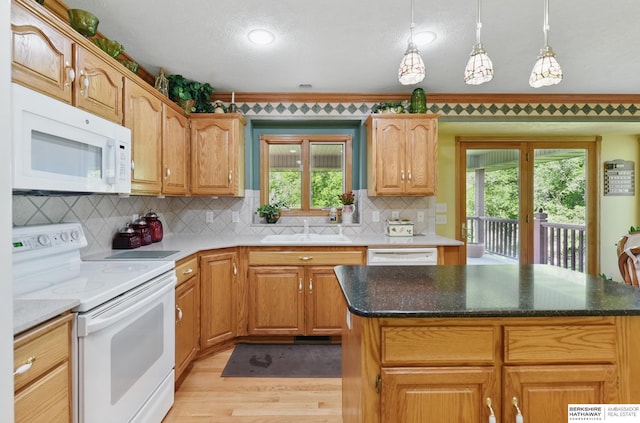 11402 Todd Dr, Blair, NE 68008 - kitchen featuring white appliances, a sink, light wood-type flooring, healthy amount of natural light, and a textured ceiling