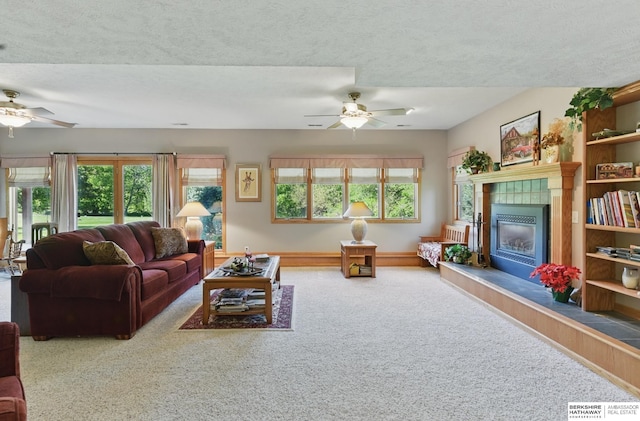 11402 Todd Dr, Blair, NE 68008 - carpeted living room with a ceiling fan, a tile fireplace, a textured ceiling, and baseboards
