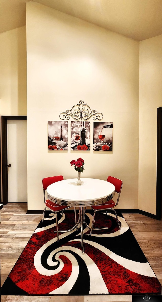 dining room featuring baseboards and light wood-style flooring