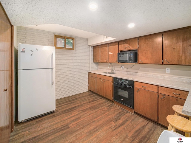 1521 Kingston Rd, Lincoln, NE 68506 - kitchen featuring dark wood-style floors, light countertops, brown cabinets, a sink, and black appliances