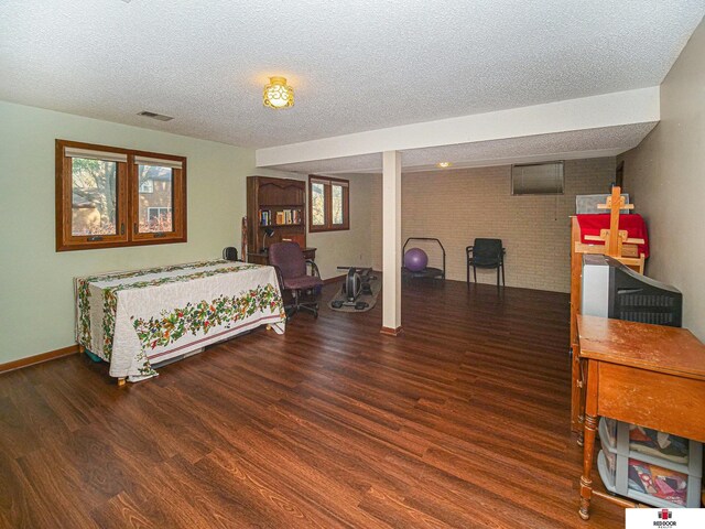 1521 Kingston Rd, Lincoln, NE 68506 - bedroom with baseboards, a textured ceiling, visible vents, and wood finished floors