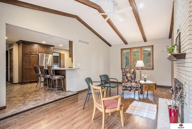 1521 Kingston Rd, Lincoln, NE 68506 - interior space featuring vaulted ceiling with beams, a ceiling fan, light wood-type flooring, and visible vents