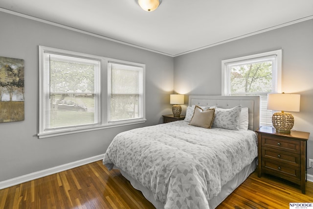bedroom featuring baseboards, ornamental molding, and wood finished floors
