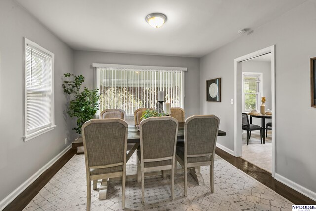 dining room with baseboards and dark wood finished floors