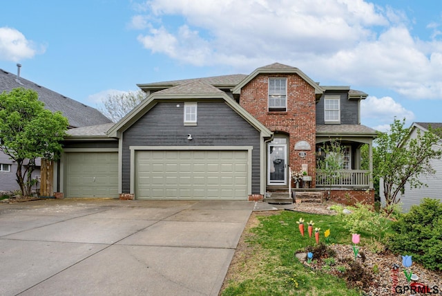 18063 Jones St, Elkhorn, NE 68022 - traditional-style house with roof with shingles, an attached garage, concrete driveway, and a porch