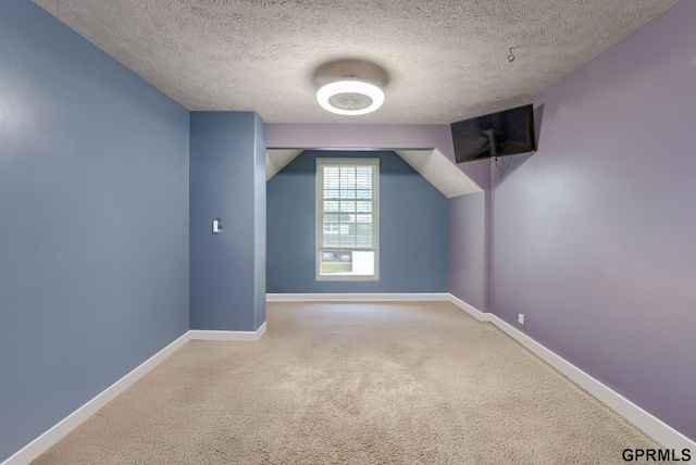 18063 Jones St, Elkhorn, NE 68022 - additional living space featuring baseboards, a textured ceiling, and carpet