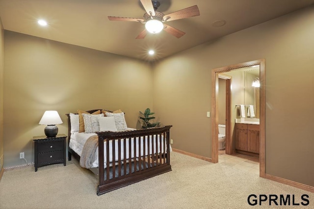 bedroom featuring connected bathroom, ceiling fan, light carpet, recessed lighting, and baseboards