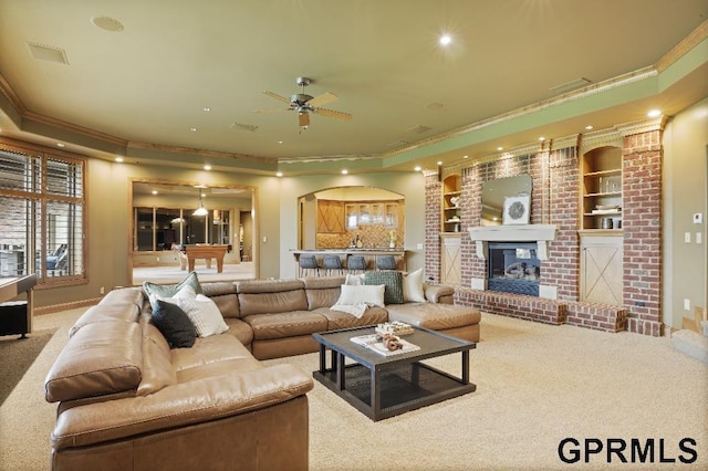 carpeted living area featuring crown molding, a ceiling fan, a tray ceiling, and recessed lighting
