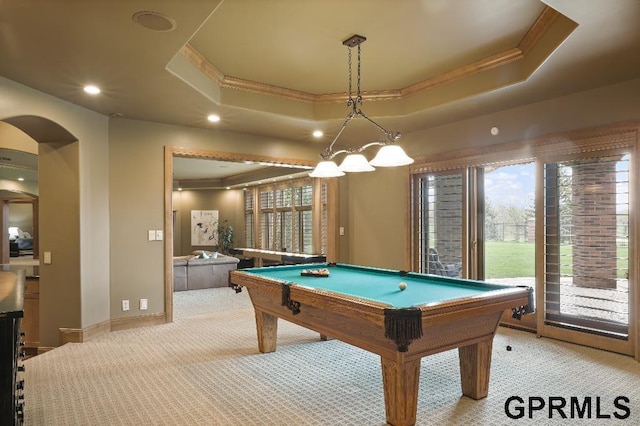 rec room with plenty of natural light, ornamental molding, a tray ceiling, and light colored carpet