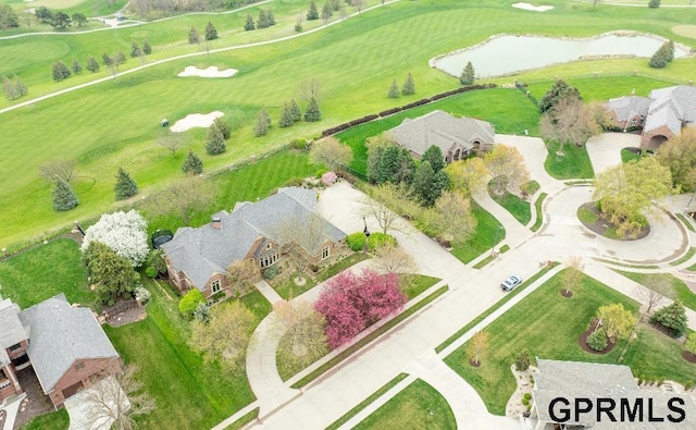 aerial view with a residential view, a water view, and golf course view