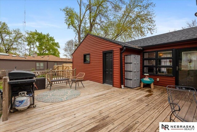 wooden terrace with a grill