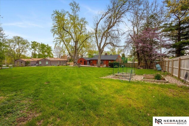view of yard with a fenced backyard and a vegetable garden