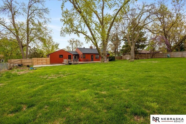 view of yard featuring a fenced backyard and a deck
