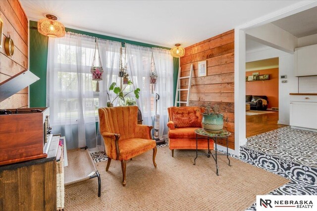 sitting room featuring wooden walls