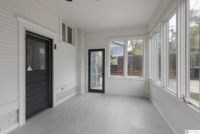 unfurnished sunroom featuring tile patterned floors