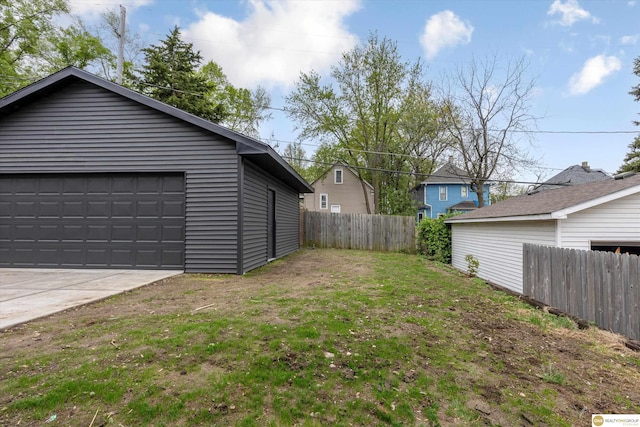 view of yard with fence and a garage