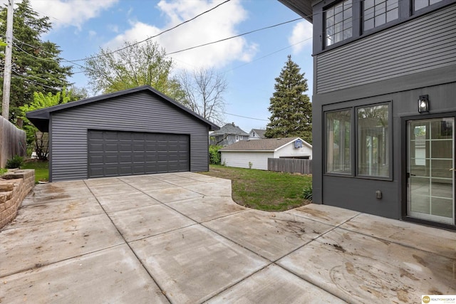 detached garage featuring fence