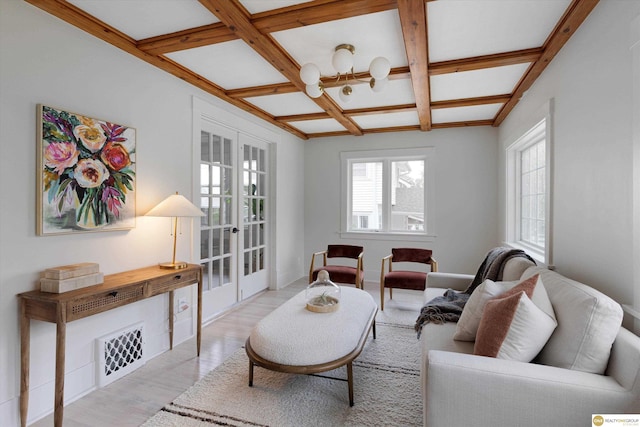 living room with beam ceiling, light wood finished floors, french doors, visible vents, and coffered ceiling