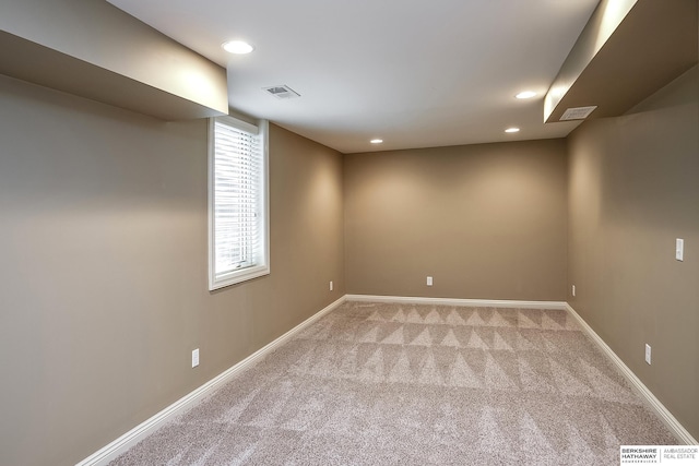 empty room featuring light carpet, baseboards, and recessed lighting