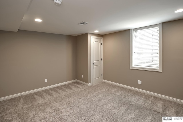 below grade area with light carpet, baseboards, and recessed lighting