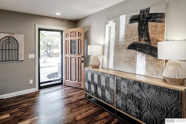 foyer entrance with dark wood finished floors, baseboards, and recessed lighting