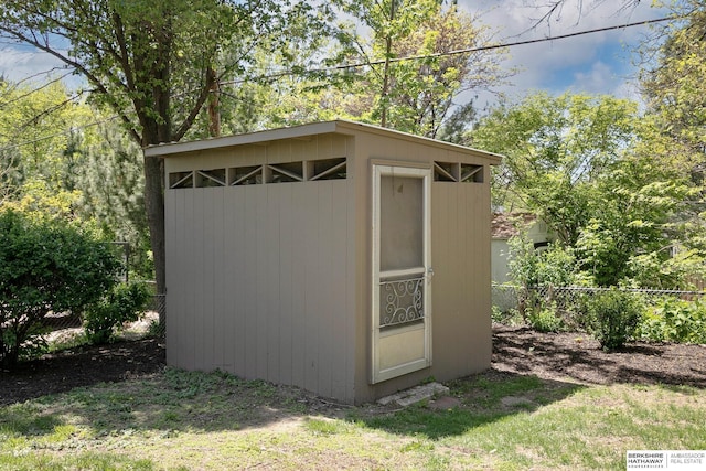 view of shed featuring fence