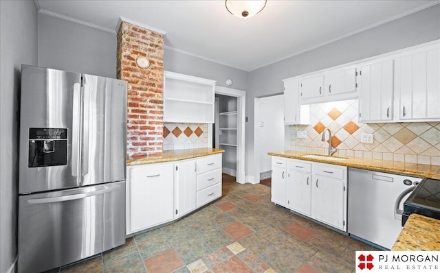 kitchen featuring stainless steel fridge, a sink, decorative backsplash, dark stone finish flooring, and white cabinets