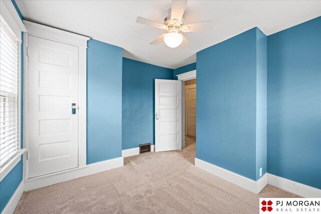 unfurnished bedroom featuring carpet flooring, baseboards, and ceiling fan