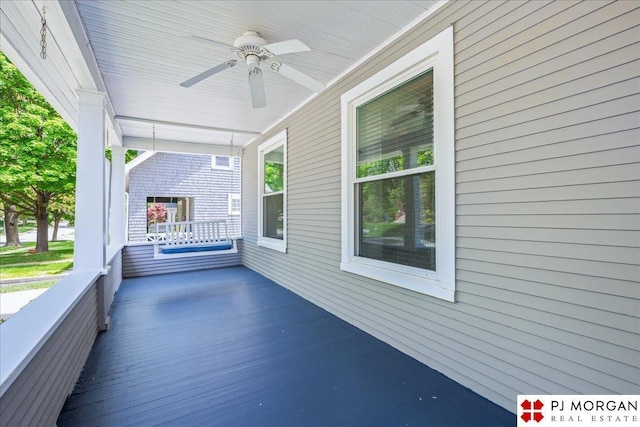 deck with ceiling fan and covered porch