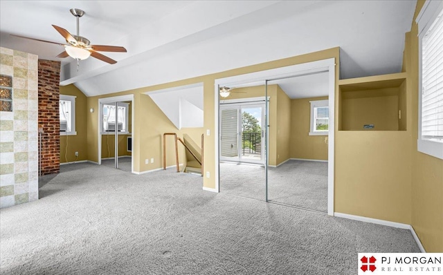 bonus room with ceiling fan, lofted ceiling, carpet flooring, and baseboards