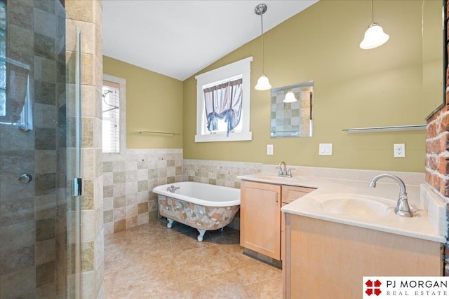 full bathroom with lofted ceiling, double vanity, a stall shower, tile walls, and a freestanding tub