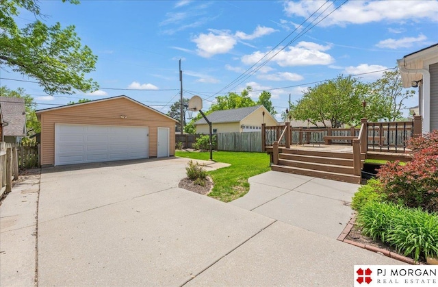 view of front of property with a wooden deck, an outdoor structure, and a garage