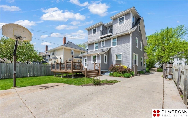 rear view of house with a residential view, a deck, and a balcony
