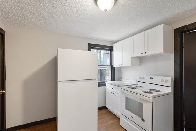 405 N 25th St, Lincoln, NE 68503 - kitchen featuring light countertops, white cabinets, white appliances, and a textured ceiling