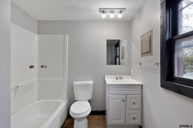 405 N 25th St, Lincoln, NE 68503 - bathroom featuring toilet, shower / bath combination, wood finished floors, and vanity