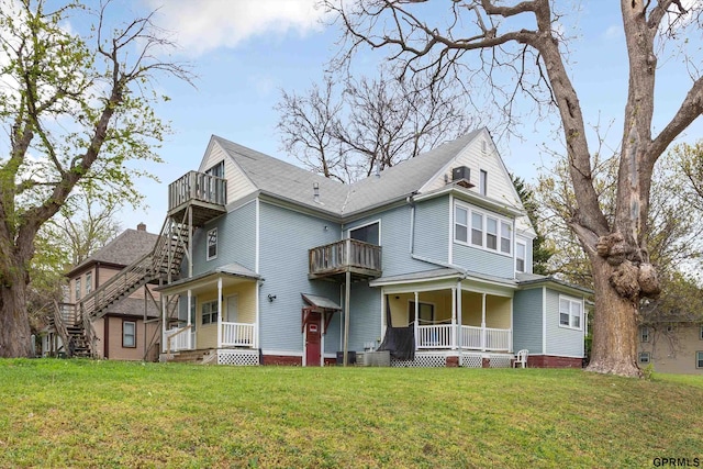 405 N 25th St, Lincoln, NE 68503 - view of front of property featuring a porch, a balcony, and a front lawn