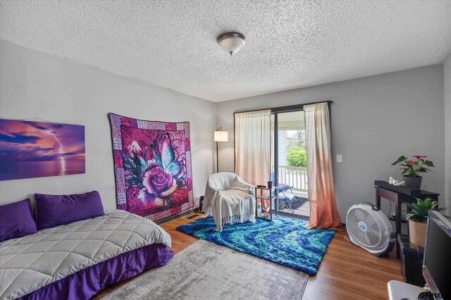 405 N 25th St, Lincoln, NE 68503 - bedroom featuring a textured ceiling, wood finished floors, and access to exterior